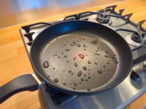 Teflon coated pan on stove. Potential dangerous chemicals in cookware, non stick frying.